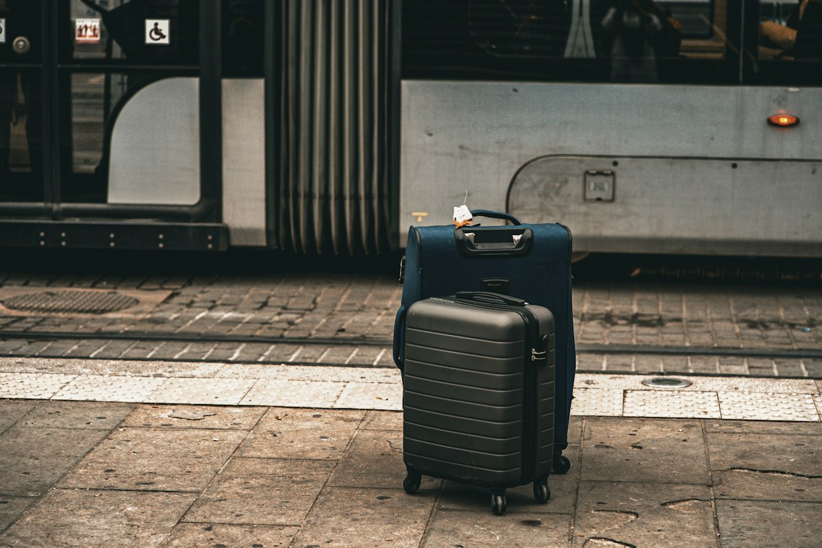 Two suitcases on a tram platform after arrival