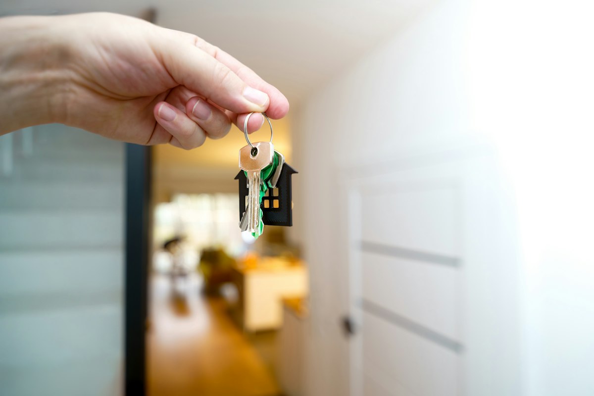 Holding the keys to a new home at the open door