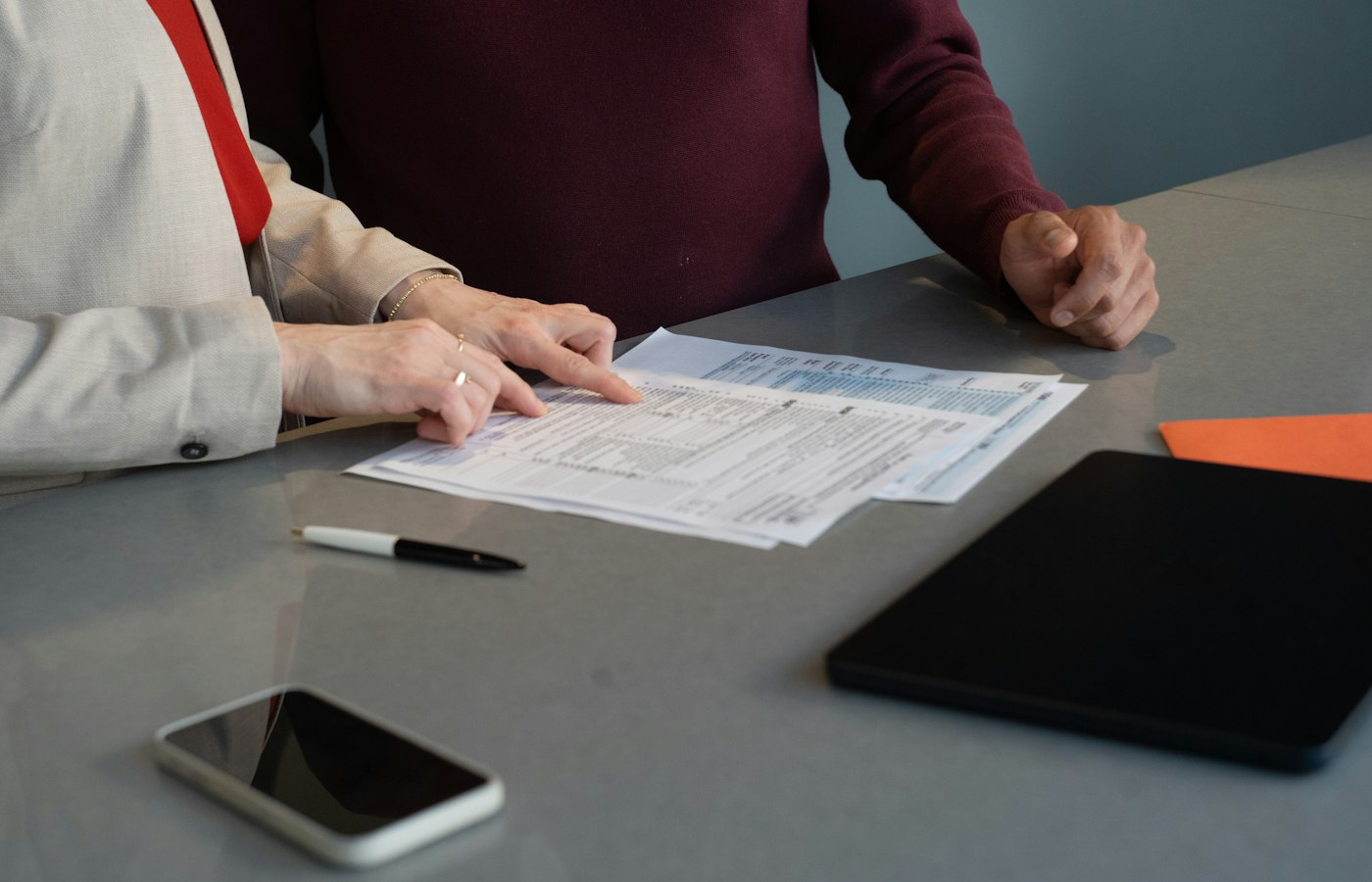 Two people going through documents at a table