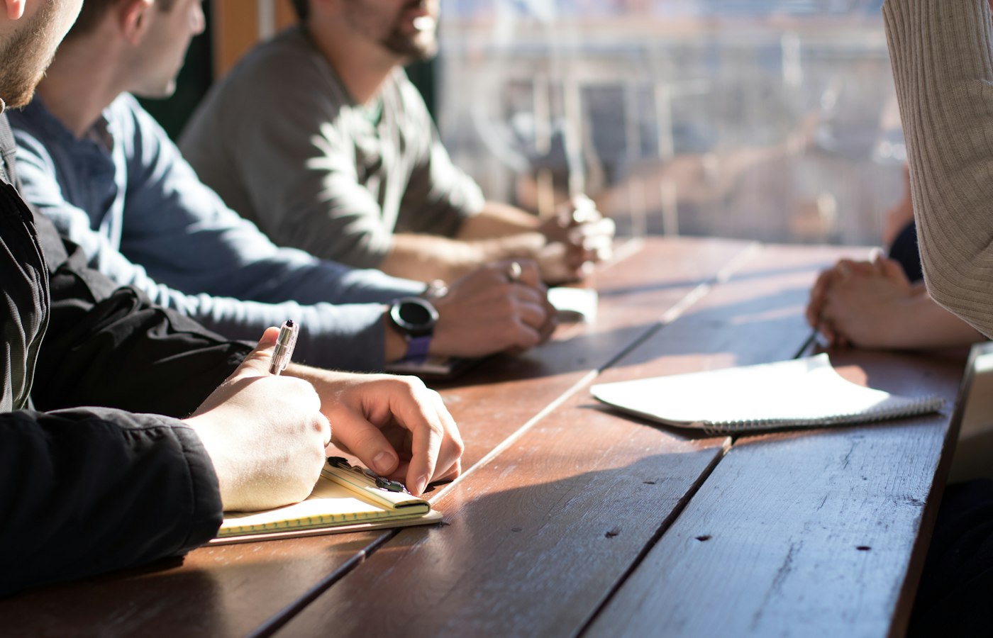 Several people working through documents at a table